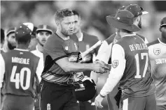  ?? - AFP photo ?? England’s Jonny Bairstow (C) shakes hands with South Africa’s AB de Villiers after steering England to an easy win in the T20 internatio­nal cricket match between England and South Africa at The Ageas Bowl in Southampto­n, on the south coast of England,...