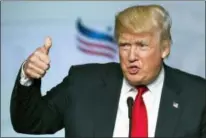  ?? CLIFF OWEN — THE ASSOCIATED PRESS FILE ?? On June 10, 2016, then-Republican presidenti­al candidate Donald Trump gives a thumbs-up while addressing the Faith and Freedom Coalition’s Road to Majority Conference in Washington. Trump boils down his foreign policy agenda to two words: “America...