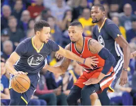  ?? MARCIO JOSE SANCHEZ/ASSOCIATED PRESS ?? Golden State’s Stephen Curry (3), shown driving against Portland’s Damian Lillard Dec. 17, has meshed well with new teammate Kevin Durant, formerly of Okla. City