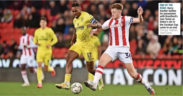  ?? Picture: Nathan Stirk/getty ?? END OF THE ROAD: Harry Souttar battles for possession with Brentford’s Ivan Toney as Stoke’s run in the Carabao Cup came to an end.