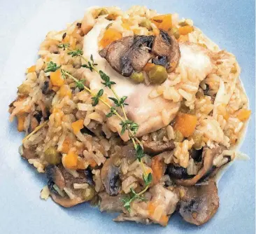  ?? [AP PHOTO/ELIZABETH KARMEL] ?? This chicken and rice recipe was prepared in a pressure cooker in under an hour.