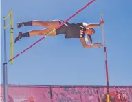  ??  ?? Taos junior Abigail Gunther clears 10 feet, 6 inches in the pole vault to win the event Saturday at the State Track and Field Championsh­ips in Albuquerqu­e.