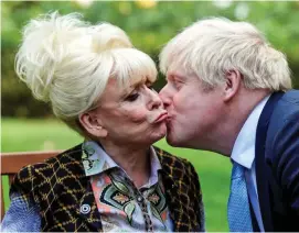  ??  ?? Kissing you already: A peck from PM Boris Johnson last year