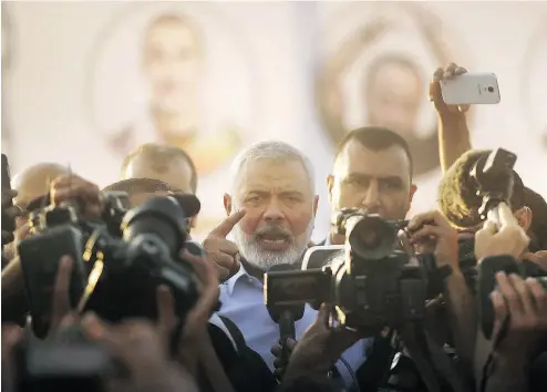  ?? SPENCER PLATT / GETTY IMAGES ?? Hamas leader Ismail Haniya speaks to protesters in Gaza City this month. Hamas keeps leading Palestinia­ns down an ever darker and narrower path that no true friend would want to see them on, writes John Robson.