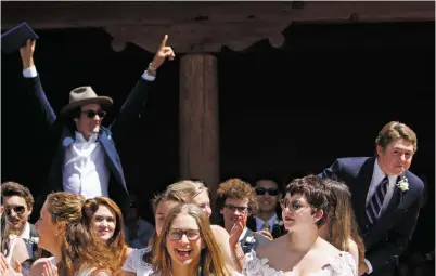  ?? PHOTOS BY LUIS SÁNCHEZ SATURNO THE NEW MEXICAN ?? LEFT: Patrick Boyd, left, cheers for classmate Thomas Naylor, right, as his name is called during the Santa Fe Prep graduation ceremony Friday.