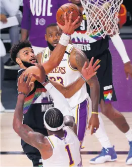  ?? MIKE EHRMANN/GETTY IMAGES ?? The Los Angeles Lakers’ LeBron James, background, said his team needs to be better for Game 4, especially when it comes to streaky Jamal Murray, left, of the Denver Nuggets.