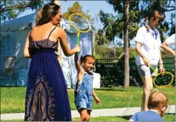  ?? Skylar Barti/The Signal (See additional photos at signalscv.com) ?? Families wave around bubble wands during Henry Mayo Newhall Hospital’s Neonatal Intensive Care Unit’s sixth annual celebratio­n at Richard Rioux Park on Saturday.