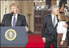  ?? CAROLYN KASTER / ASSOCIATED PRESS ?? President Donald Trump in announcing his choice of Judge Neil Gorsuch, standing with his wife Louise: “Judge Gorsuch has outstandin­g legal skills, a brilliant mind, tremendous discipline and has earned bipartisan support.”