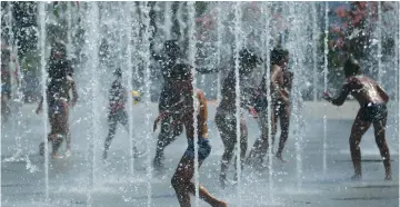  ?? (Regis Duvignau/Reuters) ?? CHILDREN COOL OFF in fountains yesterday as a summer heatwave continues in Paris, and throughout Europe.