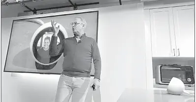  ?? AP/ELAINE THOMPSON ?? David Limp, senior vice president of devices and services at Amazon, uses an Amazon Echo Spot to chat with his wife on a monitor behind him during an event announcing several new Amazon products last week in Seattle.