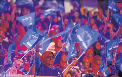  ?? AP ?? Supporters of Malaysia’s ruling party ‘National Front’ wave the party flags during the launch of manifesto in Kuala Lumpur.