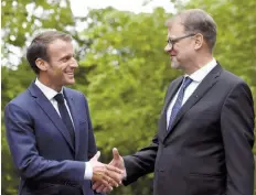  ?? — Reuters ?? French President Emmanuel Macron and Finnish Prime Minister Juha Sipila shake hands at the Prime Minister’s official residence Kesaranta in Helsinki on Thursday.