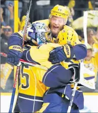  ?? MARK HUMPHREY / ASSOCIATED PRESS ?? Nashville Predators goalie Pekka Rinne is mobbed by teammates after backstoppi­ng the Preds to Monday’s 6-3 home win over the Anaheim Ducks to clinch the NHL’s Western Conference championsh­ip. Nashville will face the winner of the Pittsburgh-Ottawa...