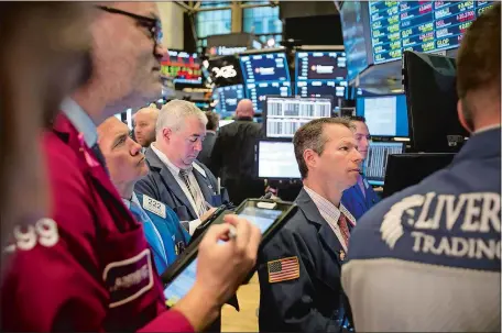  ?? MICHAEL NAGLE/BLOOMBERG ?? Traders work on the floor of the New York Stock Exchange in New York last week. “Just about anything can create panic, create contagion, and it doesn’t have to be something that makes sense,” says Malcolm Polley, who oversees $1.2 billion as president of Stewart Capital Advisors LLC in Indiana, Pa.