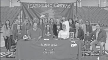  ?? TONY LENAHAN/ The Saline Courier ?? Harmony Grove senior Hailey Webb, sitting center, poses with friends, family and teammates after signing with the Central Baptist College Mustangs on Friday.