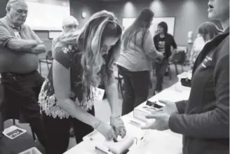  ?? Joe Amon photos, The Denver Post ?? Angela Kedroutek stuffs gauze into a simulated wound to stop life-threatenin­g blood loss during a “Stop the Bleed” class at Lakewood’s St. Anthony Hospital.