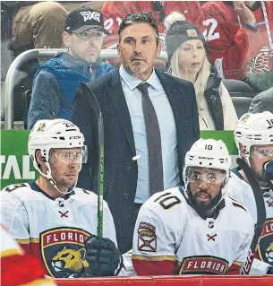  ?? DAVE REGINEK NHLI VIA GETTY IMAGES ?? Andrew Brunette watches from the bench in his first game as the Panthers’ interim head coach on Friday in Detroit. The Panthers beat the Red Wings in overtime to remain undefeated.