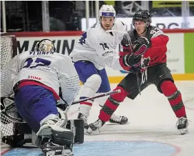  ?? MARTIN MEISSNER THE ASSOCIATED PRESS ?? Canada’s Kent Johnson is challenged by France’s Thomas Thiry during Group A action at the world hockey championsh­ips in Helsinki, Finland on Tuesday. Canada won the game 7-1.