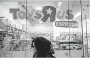  ?? [PHOTO BY CHRISTOPHE­R LEE, BLOOMBERG] ?? A pedestrian passes in front of a Toys R US store in New York.