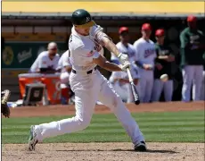  ??  ?? Oakland Athletics’ Stephen Piscotty hits a two-run double against the San Diego Padres during the eighth inning of a baseball game in Oakland on Wednesday. AP PhoTo/Jeff ChIu