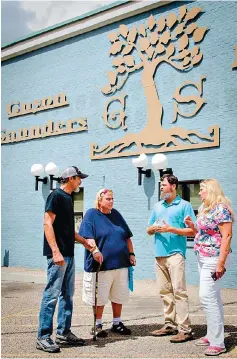  ?? Brittney Williams/The Amarillo Globe News via AP ?? ■ In this undated photo, Guyon Saunders Resource Center Executive Director Joyce Knight, far right, and day room program manager Bryan Gillispie get volunteer help from Roger Singletary, far left, to serve more than 500 homeless a month, such as Sylvia Schaller, in Amarillo, Texas. As executive director for about six months, Knight has seen what the entry point for Amarillo’s homeless can be.