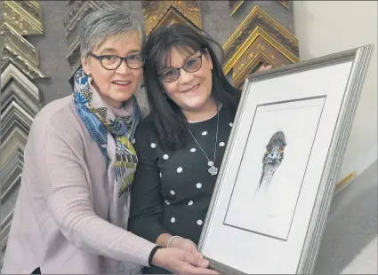  ?? Picture: PAUL CARRACHER ?? FINAL TOUCHES: Horsham artist Debbie Russell, right, with one of her entries for this year’s Horsham East Rotary Wimmera Art Fair. She is pictured with Anna Stephan from Conserve Framing, preparing her piece for exhibit.