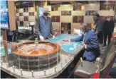  ?? ETHAN MILLER/GETTY IMAGES ?? Dealer Gary Reed looks on while a couple of people play roulette at Bellagio Resort & Casino on the Las Vegas Strip last week.