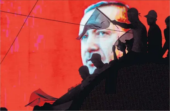  ?? Chris McGrath Getty Images ?? THE FACE of President Recep Tayyip Erdogan shines from an electronic billboard over a rally on Kizilay Square in Ankara, Turkey’s capital, after the failed coup.