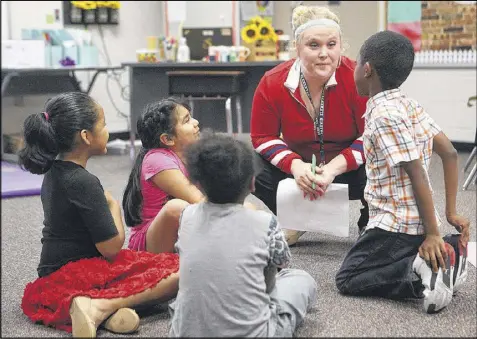  ??  ?? Audrey Smith talks to her first-grade students about who their new teachers will be next year. Looking back over her first year, Smith said some days were really tough. “You kind of bang your head against the wall and say ‘I don’t know what I can do....