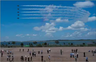  ?? VINCENT THIAN — THE ASSOCIATED PRESS ?? South Korean Air Force’s Black Eagles aerobatic team performs during the first day of the Singapore Airshow in Singapore.