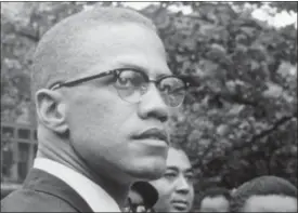  ?? ROBERT HAGGINS — THE ASSOCIATED PRESS FILE ?? In this 1963file photo, Black Nationalis­t leader Malcolm X attends a rally at Lennox Avenue and 115th Street in the Harlem neighborho­od of New York.