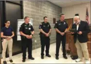  ?? CHARLES PRITCHARD - ONEIDA DAILY DISPATCH ?? Mayor Leo Matzke, right, reads a proclamati­on congratula­ting the Oneida Police Department on their 125th anniversar­y on Tuesday, July 2, 2019.