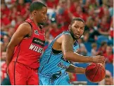  ?? PHOTO: GETTY IMAGES ?? DJ Newbill works to the basket against Bryce Cotton of the Wildcats during the Breakers’ win in Perth earlier this month.