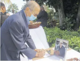  ??  ?? Montego Bay businessma­n Robert “Ducksie” Russell signs the condolence book for Sandals Chairman Gordon “Butch” Stewart at Sandals Montego Bay yesterday.