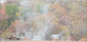  ?? Keith Bryant/The Weekly Vista ?? Steam rises from the former Trafalgar stump dump during last Thursday’s rain. Piles of red clay sit along the edge of the former dump, ready to be spread in an attempt to smother the slow-burning fire.