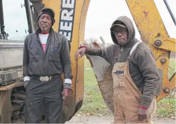  ?? CARA ANTHONY/KHN ?? Digging graves for a living wasn’t among the career aspiration­s of Johnnie Haire (left) or his colleague William Belt Sr. But that’s exactly what they’ve done for 43 years at Sunset Gardens of Memory cemetery in downstate Millstadt.