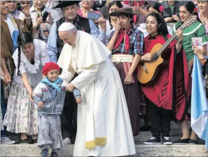  ?? PICTURE: EPA ?? Pope Francis greets a young Argentinia­n at the end of his weekly general audience in St Peter’s Square at the Vatican yesterday.