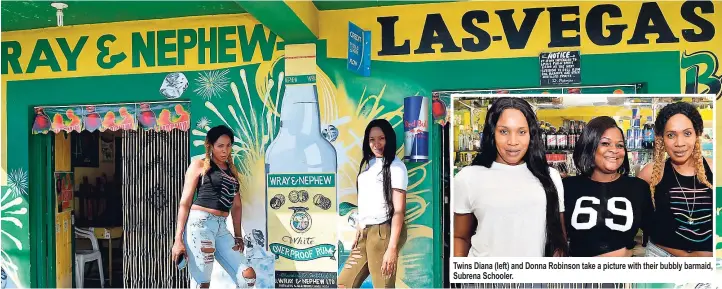  ??  ?? Twins Diana (left) and Donna Robinson take a picture with their bubbly barmaid, Subrena Schooler.