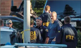  ?? IRFAN KHAN/LOS ANGELES TIMES ?? FBI investigat­ors and the Orange County Sheriff department continue investigat­ing on Wednesday following an explosion and fire at a medical building that killed a woman and injured at least three other people Tuesday afternoon in Aliso Viejo.