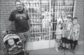  ?? Photo courtesy of Erin States Hoy ?? ERIN STATES HOY, husband Ben and four children last year visited the Hall of Fame, where a display of the 1994 baseball strike includes a photo of her as a child.
