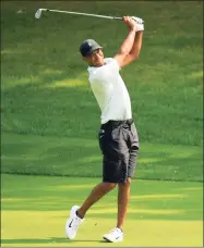  ?? Andy Lyons / Getty Images ?? Tiger Woods hits a shot during a practice round for the BMW Championsh­ip at Olympia Fields Country Club on Tuesday.