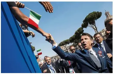  ?? — AP ?? Reaching out: Conte being greeted by citizens during the celebratio­n of Italy’s Republic Day in Rome.