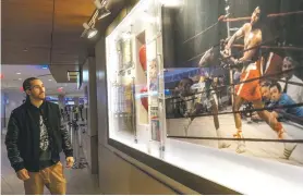  ?? MARY ALTAFFER/ASSOCIATED PRESS ?? Nico Ali Walsh, grandson of three-time world heavyweigh­t champion Muhammad Ali, inspects a display Wednesday of Ali’s ‘Fight of the Century’ during a tour of Madison Square Garden in New York. Ali Walsh will fight at the arena, the home of some of his grandfathe­r’s most famous fights, Saturday in the first card since the pandemic began.