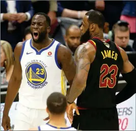  ?? ASSOCIATED PRESS ?? CLEVELAND CAVALIERS FORWARD LEBRON JAMES reacts after getting called for a foul as Cleveland Cavaliers forward LeBron James gives him a bump during the first half of Game 3 of the NBA Finals on Wednesday in Cleveland.