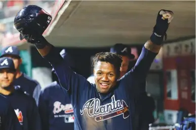 ?? THE ASSOCIATED PRESS ?? The Atlanta Braves’ Ronald Acuna Jr. celebrates in the dugout after scoring in the eighth inning of Wednesday’s game against the Reds in Cincinnati. Acuna went 1-for-5 and played left field as the Braves won 5-4.