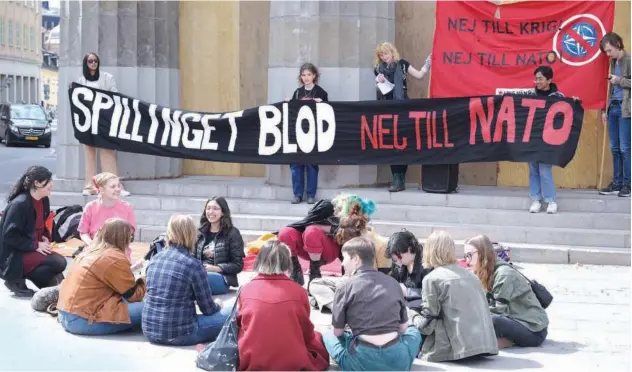  ?? Associated Press ?? ↑
Demonstrat­ors hold up banners with writing reading in Swedish ‘Spilling Blood, No to Nato’ during a protest outside the Swedish Parliament in Stockholm on Monday.