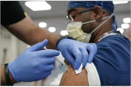  ?? LYNNE SLADKY — THE ASSOCIATED PRESS FILE ?? A health care worker receives a Pfizer COVID-19booster shot at Jackson Memorial Hospital in Miami.