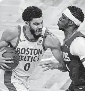  ?? Elise Amendola / Associated Press ?? The Celtics’ Jayson Tatum encounters tight defense from the Clippers’ Reggie Jackson.