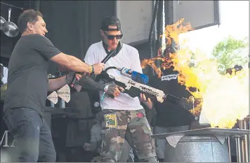  ?? CHRIS RILEY — STAFF PHOTOGRAPH­ER ?? Chef Michael Voltaggio uses a Boring Company flamethrow­er to blacken some chicken on the Williams Sonoma Culinary Stage on Saturday at BottleRock in Napa.