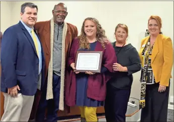  ?? sean Williams ?? Amanda Woodham (center) is the 2019-2020 Teacher of the Year for Polk School District. She was joined by Principal Dr. David Wilds, Board Chair Bernard Morgan, Superinten­dent Laurie Atkins and Assistant Superinten­dent Dr. Katie Thomas.